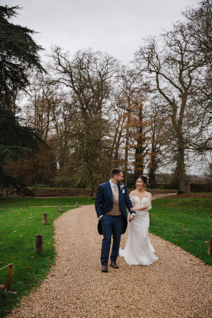 Elcott Park wedding photography with couple standing outside manor