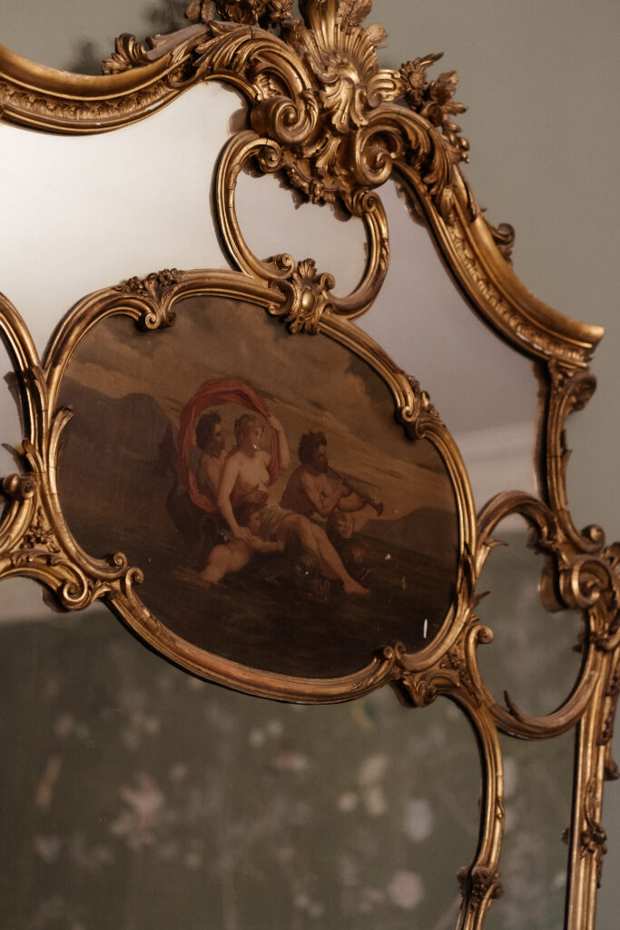 Couple drinking cocktails by the fire at Elcott Park for wedding