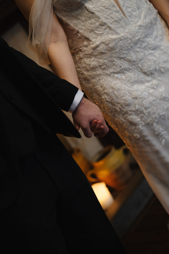 Couple drinking cocktails by the fire at Elcott Park for wedding