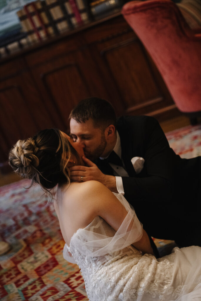 Couple drinking cocktails by the fire at Elcott Park for wedding