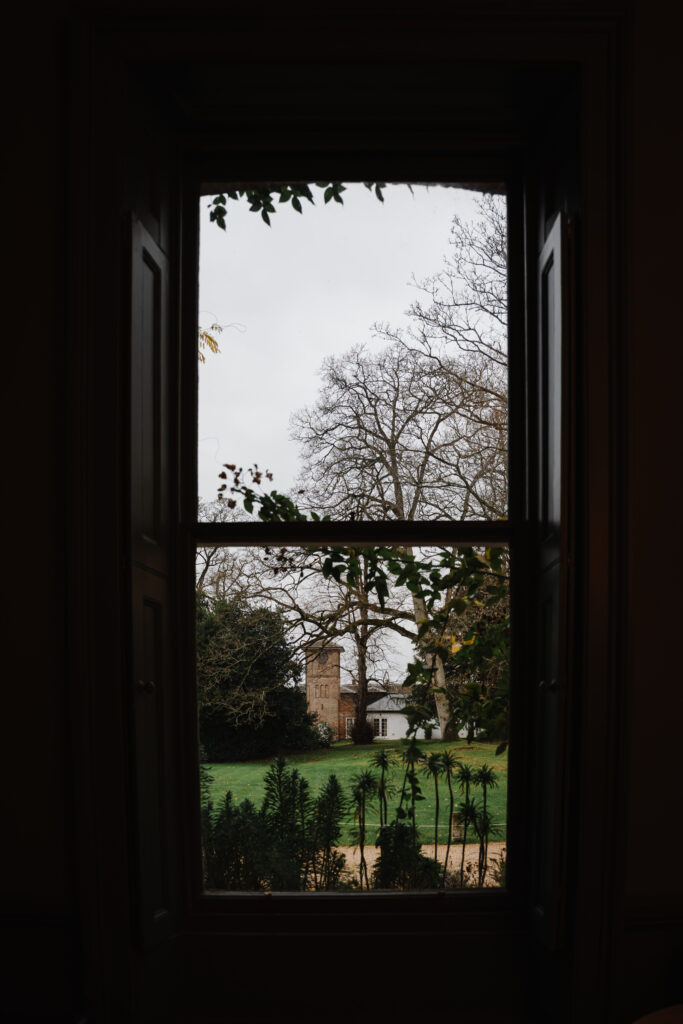 Couple drinking cocktails by the fire at Elcott Park for wedding