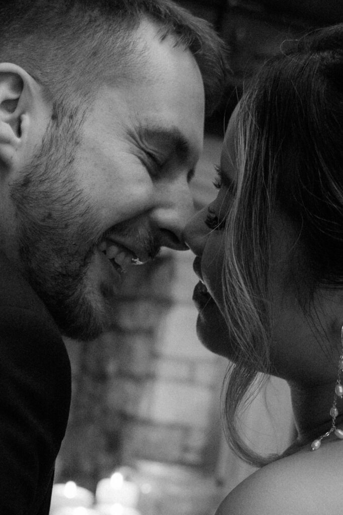 Couple drinking cocktails by the fire at Elcott Park for wedding