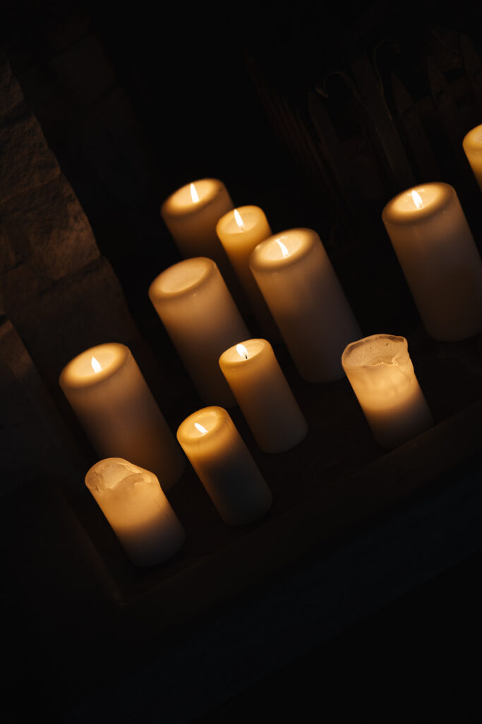 Couple drinking cocktails by the fire at Elcott Park for wedding