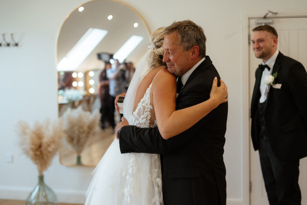 feather of the bride reveal at Bridal Prep at Hyde House by Cotswolds wedding photographer