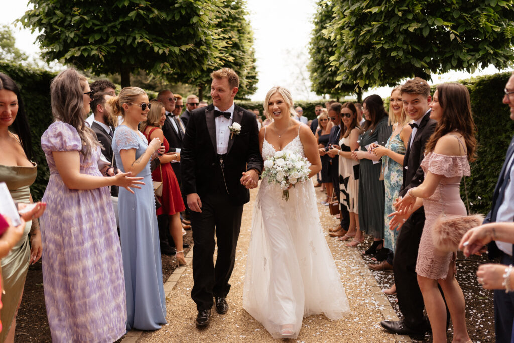 Bride and groom confetti photo at Hyde House by Cotswolds wedding photographer