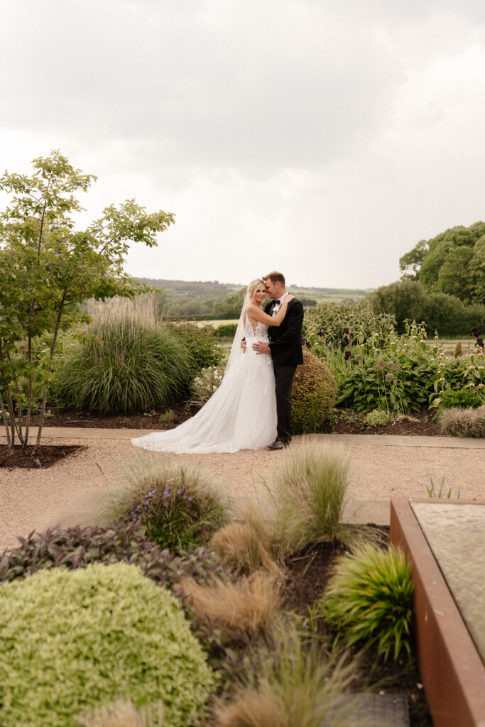 bride and groom at golden hour at hyde house by cotswolds wedding photographer