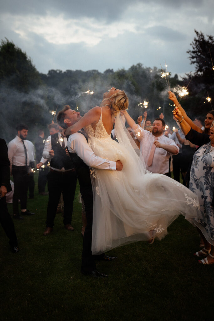 bride and groom during sparklers exit at hyde house by cotswolds wedding photographer
