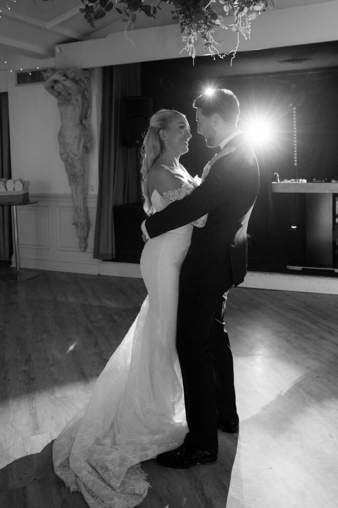 Manor by the Lake bride and groom at first dance by Cotswolds wedding photographer