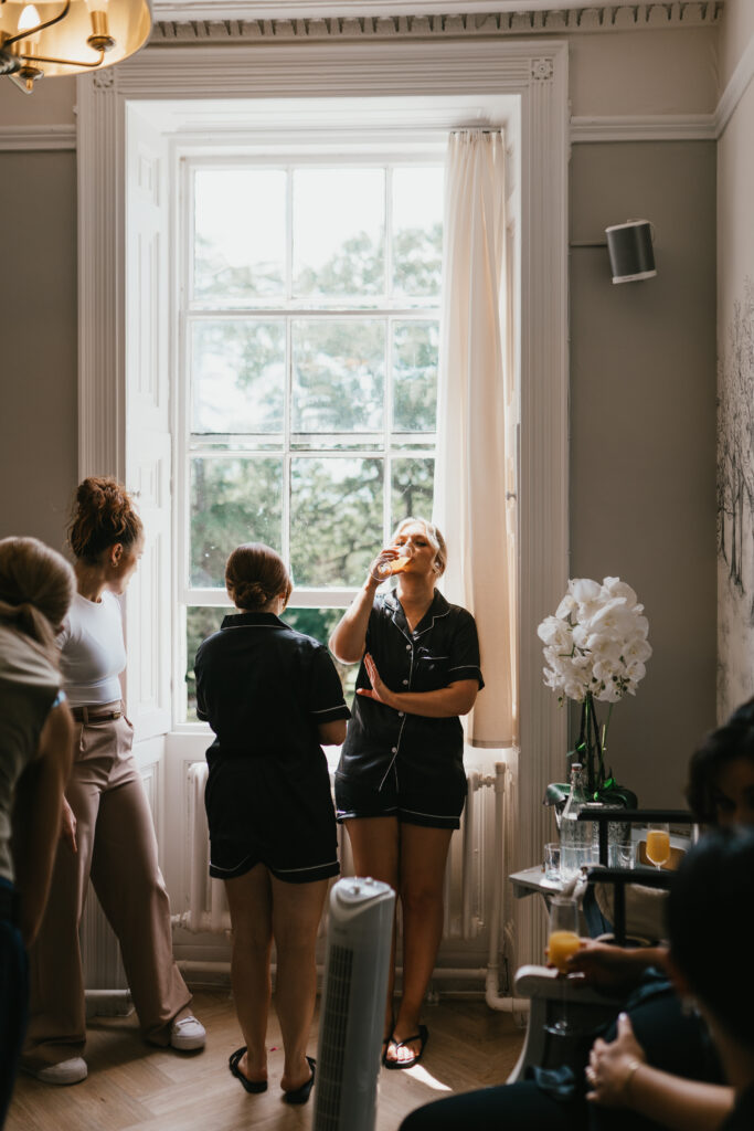 Eastington Park bridal party natural photo by Cotswolds wedding photographer