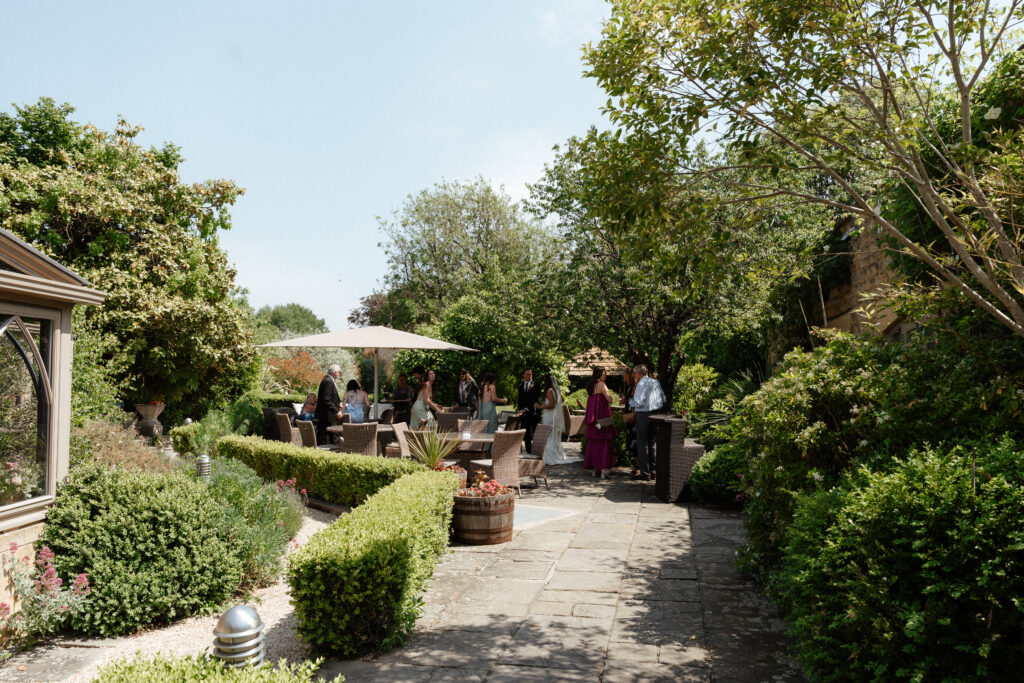 cocktail hour for wedding at manor house hotel by cotswolds wedding photographer