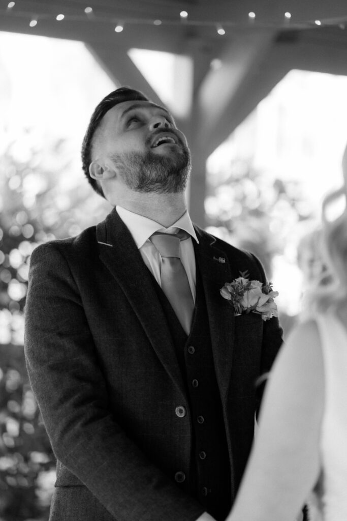 outdoor ceremony under a pergola at brinsop court for autumn wedding by hereford wedding photographer