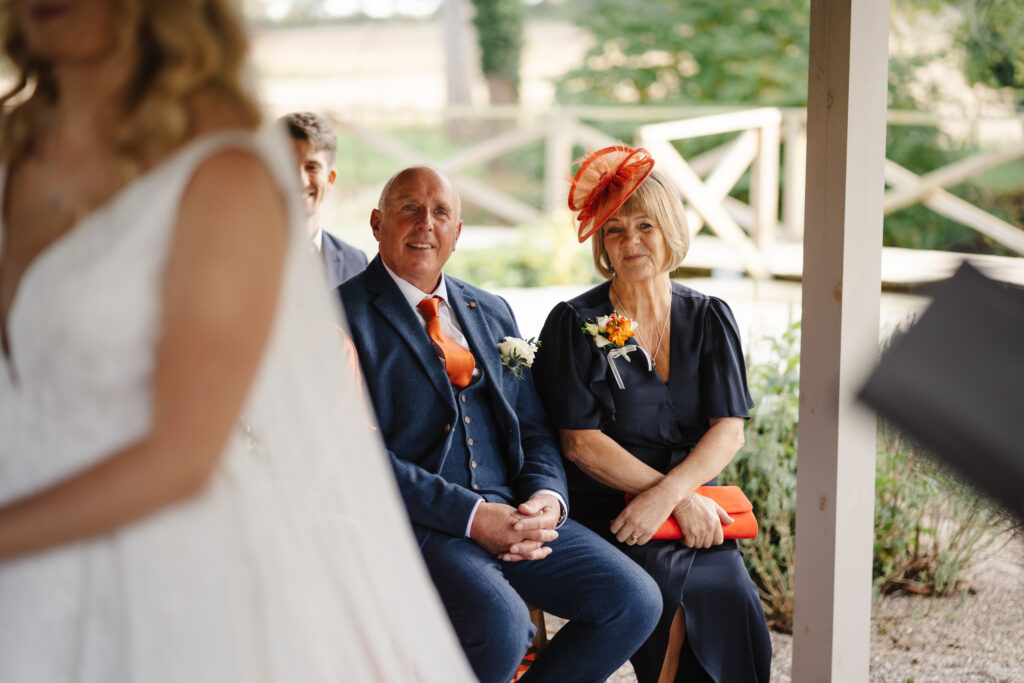 outdoor ceremony under a pergola at brinsop court for autumn wedding by hereford wedding photographer