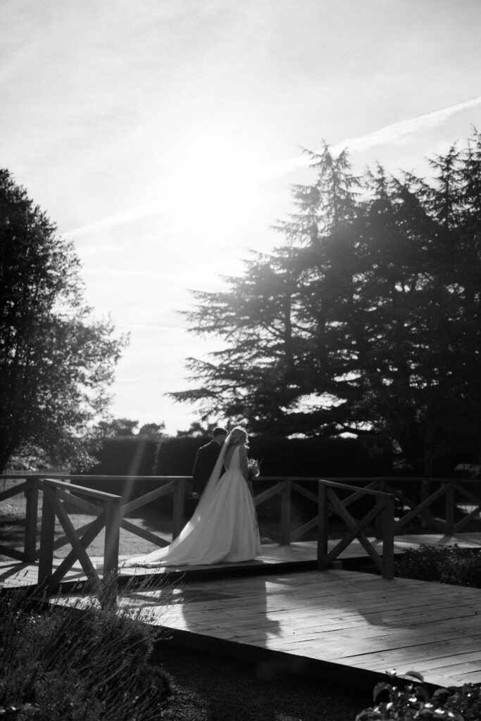 outdoor ceremony under a pergola at brinsop court for autumn wedding by hereford wedding photographer