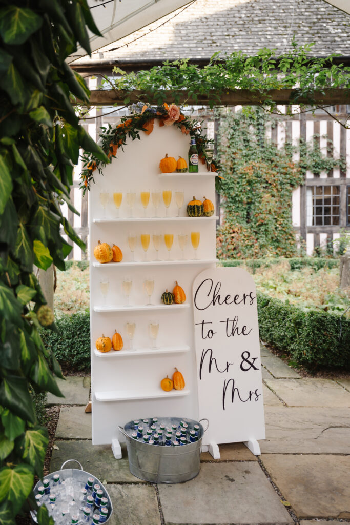 outdoor ceremony under a pergola at brinsop court for autumn wedding by hereford wedding photographer