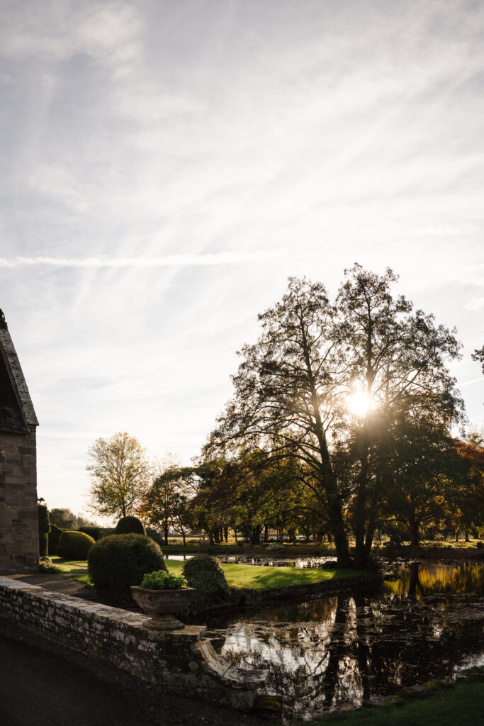 outdoor ceremony under a pergola at brinsop court for autumn wedding by hereford wedding photographer