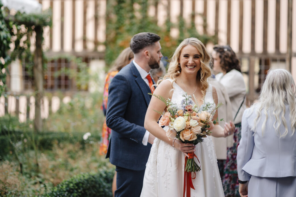 outdoor ceremony under a pergola at brinsop court for autumn wedding by hereford wedding photographer